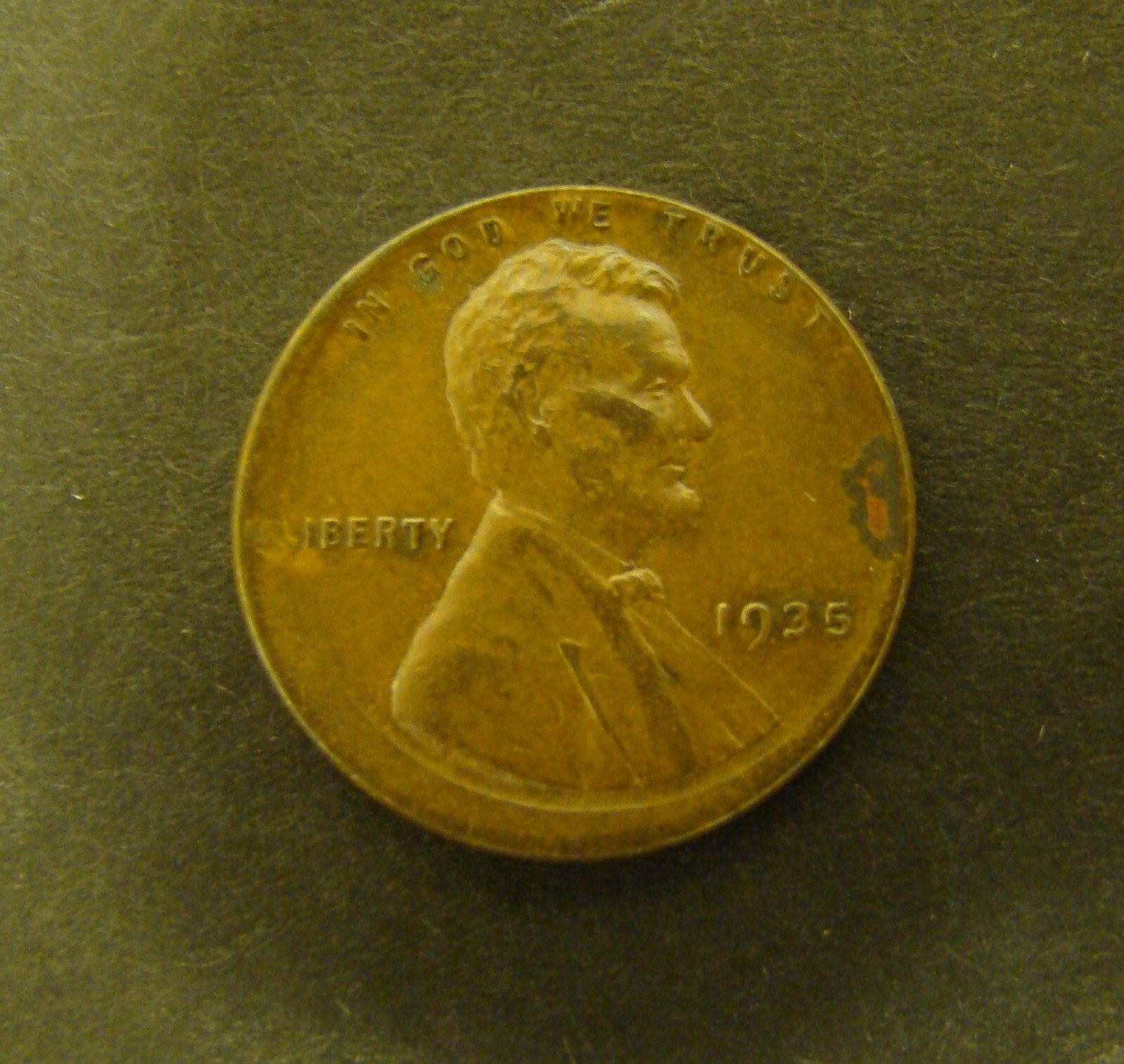 1935 wheat penny off-center strike error showing blank crescent and shifted Lincoln design